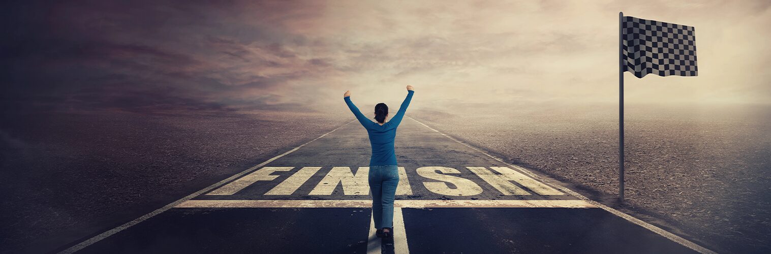 grungy photo of a woman about to cross a finish line