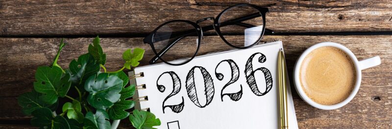 glasses, coffee, a pen, and a notebook with "2026" written in it